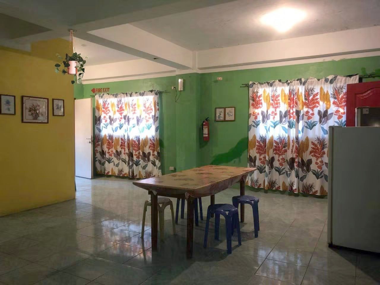 Dining area near the fridge and fire exit.