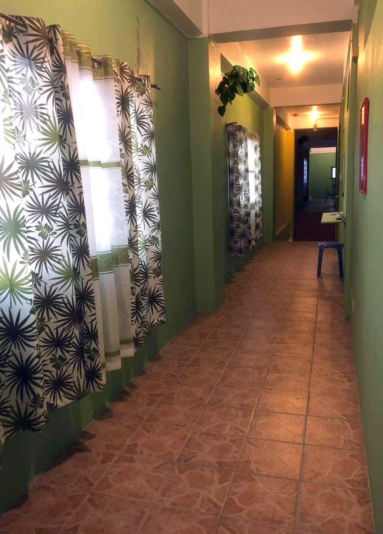 The hallway between rooms, lit into the evening.